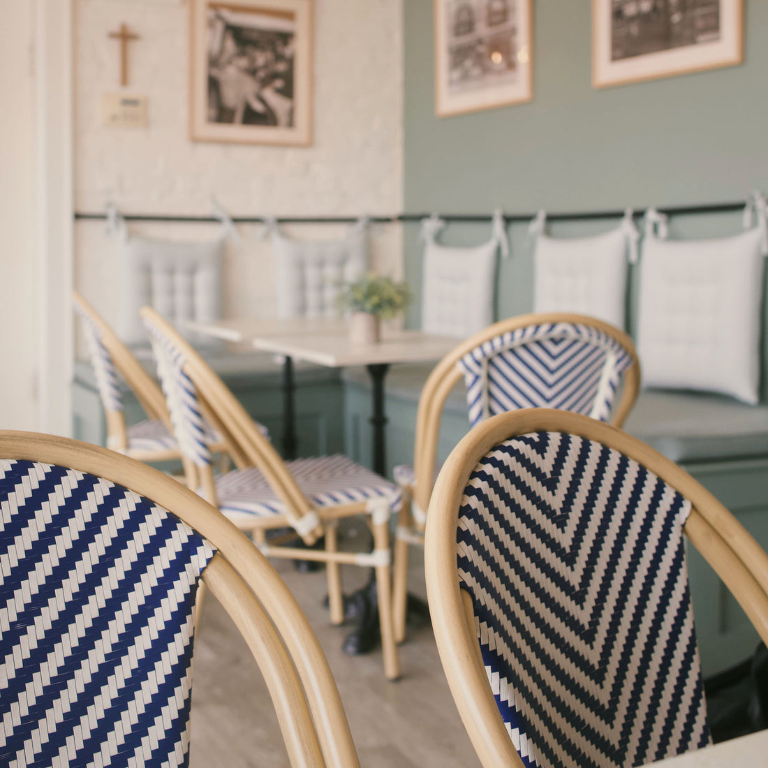 Café interior with striped chairs and tables.