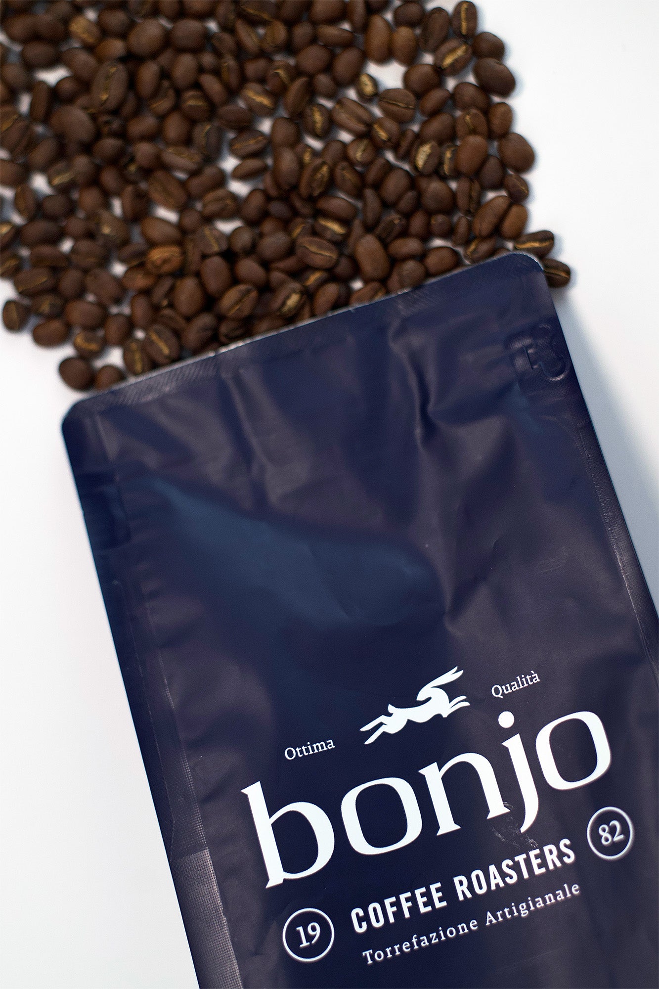 Bonjo Coffee Roasters packaging with coffee beans on a white background